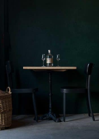Distillerie Porrentruy Bouteille sur table et chaises